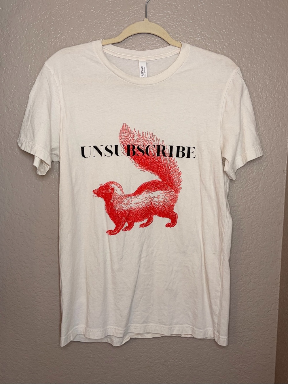 Bella Canvas Cream Tee with Red Skunk Graphic
